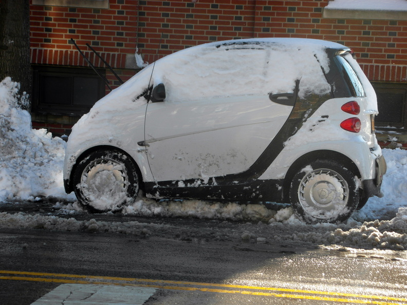 Smart Car smartly uncovered of its snow blanket