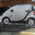 Smart Car smartly uncovered of its snow blanket